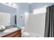 Clean bathroom featuring white tile and updated vanity with granite countertop at 5119 Admiral Pointe Dr, Apollo Beach, FL 33572