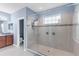 Modern bathroom featuring glass shower with tile surround and granite vanity at 5119 Admiral Pointe Dr, Apollo Beach, FL 33572