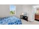 Charming bedroom with window, features soft carpet and a modern TV stand with cabinet at 5119 Admiral Pointe Dr, Apollo Beach, FL 33572