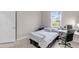 Comfortable bedroom with neutral tones, large window, and built-in study space for a relaxing atmosphere at 5119 Admiral Pointe Dr, Apollo Beach, FL 33572