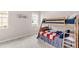 Cozy bedroom featuring a bunk bed and natural light from the window at 5119 Admiral Pointe Dr, Apollo Beach, FL 33572