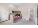 Cozy bedroom featuring a wooden bunk bed, plush carpet, and doorway to the rest of the home at 5119 Admiral Pointe Dr, Apollo Beach, FL 33572
