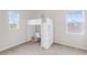 Bedroom featuring a white, elevated bed and a built-in desk under a bright window at 5119 Admiral Pointe Dr, Apollo Beach, FL 33572