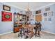 Fun dining room with hardwood barrel table and chairs under decorative chandelier at 5119 Admiral Pointe Dr, Apollo Beach, FL 33572