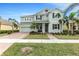 Inviting two-story home boasting a manicured lawn, palm trees and driveway at 5119 Admiral Pointe Dr, Apollo Beach, FL 33572