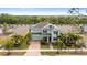 Aerial view of a two-story home featuring professional landscaping and a brick driveway at 5119 Admiral Pointe Dr, Apollo Beach, FL 33572