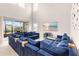 Large living room with beach view art on wall, and access to lanai with seating at 5119 Admiral Pointe Dr, Apollo Beach, FL 33572