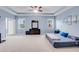 Spacious main bedroom features a tray ceiling, plush carpet, and large windows offering lots of natural light at 5119 Admiral Pointe Dr, Apollo Beach, FL 33572