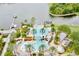 Aerial photo of outdoor pools with a water slide and lounge areas, plus a dock on the lake at 5119 Admiral Pointe Dr, Apollo Beach, FL 33572