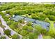Aerial shot of multiple outdoor tennis courts surrounded by trees and a small pond at 5119 Admiral Pointe Dr, Apollo Beach, FL 33572