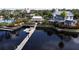 Photo of a pier, kayaks, and nearby buildings, including the community clubhouse and pool at 5119 Admiral Pointe Dr, Apollo Beach, FL 33572