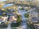 Aerial view of the property in a tranquil neighborhood setting, surrounded by lush greenery and a serene lake at 5139 50Th W Ave, Bradenton, FL 34210