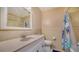 Bathroom showcasing a vanity, toilet, mirror, and a shower with blue accent at 5525 Shadow Lawn Dr, Sarasota, FL 34242