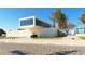 Modern beach building featuring a glass-enclosed upper level and unique textured walls at 5525 Shadow Lawn Dr, Sarasota, FL 34242