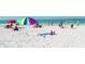 People enjoying Siesta Key Beach with colorful umbrellas and chairs on a sunny day at 5525 Shadow Lawn Dr, Sarasota, FL 34242