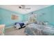 Coastal themed bedroom with two twin beds and bright blue walls at 5525 Shadow Lawn Dr, Sarasota, FL 34242
