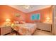 Comfortable bedroom with warm colors, a queen bed, and classic furnishings at 5525 Shadow Lawn Dr, Sarasota, FL 34242