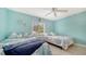 Charming bedroom with two twin beds, coastal-themed decor, and plenty of natural light at 5525 Shadow Lawn Dr, Sarasota, FL 34242
