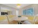 Bright dining area with a round table, seating for four, and natural light from the windows at 5525 Shadow Lawn Dr, Sarasota, FL 34242