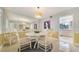 Cozy dining room featuring a white table, patterned chairs, and a mirrored wall for added spaciousness at 5525 Shadow Lawn Dr, Sarasota, FL 34242