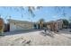 Charming brick and siding home featuring a large, paved driveway and a well-manicured front yard at 5525 Shadow Lawn Dr, Sarasota, FL 34242