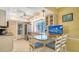 Open kitchen with granite countertops, stainless steel appliances, and a cozy breakfast bar at 5525 Shadow Lawn Dr, Sarasota, FL 34242
