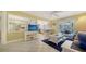 Relaxing living room connected to kitchen, featuring tile floors, pool view, and casual seating at 5525 Shadow Lawn Dr, Sarasota, FL 34242