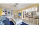 Bright living room and kitchen feature tile floors, built-in shelving, and a breakfast bar for casual dining at 5525 Shadow Lawn Dr, Sarasota, FL 34242