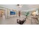 Living room with tiled floors, built in shelves, a full mirrored wall, and neutral tones at 5525 Shadow Lawn Dr, Sarasota, FL 34242