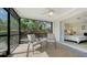 Cozy screened lanai with ceiling fan and access to the bedroom via sliding glass door at 5525 Shadow Lawn Dr, Sarasota, FL 34242