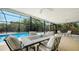 Dine al fresco on this screened patio with comfortable seating and pool views, perfect for entertaining at 5525 Shadow Lawn Dr, Sarasota, FL 34242