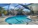 A screened-in pool features pristine water and a sunny atmosphere at 5525 Shadow Lawn Dr, Sarasota, FL 34242