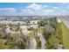 Scenic aerial view of Tidewater Preserve community with lush landscaping, waterfront homes, and a glimpse of the highway nearby at 5608 Tidewater Preserve Blvd, Bradenton, FL 34208