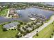 Aerial view of community amenities including marina, tennis courts, and waterfront homes surrounding the lake at 5608 Tidewater Preserve Blvd, Bradenton, FL 34208