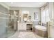 This bright bathroom features a large glass shower, a separate soaking tub, and lots of natural light at 5608 Tidewater Preserve Blvd, Bradenton, FL 34208