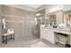This bathroom has a spacious walk-in shower with mosaic accents, dual sinks, and elegant decor at 5608 Tidewater Preserve Blvd, Bradenton, FL 34208