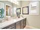 Stylish bathroom featuring quartz counters, dark wood cabinets, and a modern seahorse statue at 5608 Tidewater Preserve Blvd, Bradenton, FL 34208
