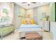 This colorful bedroom features bright artwork, patterned pillows, and lots of natural light from the window at 5608 Tidewater Preserve Blvd, Bradenton, FL 34208