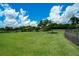 Expansive community dog park features lush green grass, shaded benches, and secure fencing for pets to enjoy at 5608 Tidewater Preserve Blvd, Bradenton, FL 34208