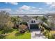 Beautiful home featuring lush landscaping, and a scenic waterfront view, with a paver driveway and a two-car garage at 5608 Tidewater Preserve Blvd, Bradenton, FL 34208