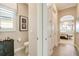 Hallway leads to a bathroom and main bedroom with an elegant chandelier and neutral decor at 5608 Tidewater Preserve Blvd, Bradenton, FL 34208