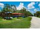 A variety of colorful kayaks are stored on a wooden rack near a picturesque path and waterway at 5608 Tidewater Preserve Blvd, Bradenton, FL 34208