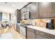 Gourmet kitchen with stainless steel appliances, dark cabinets, and quartz countertops at 5608 Tidewater Preserve Blvd, Bradenton, FL 34208