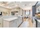 Bright kitchen with white quartz counters, stainless appliances, and views to the dining room at 5608 Tidewater Preserve Blvd, Bradenton, FL 34208