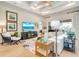 Bright living room with a coffered ceiling, hardwood floors, and a cozy seating area at 5608 Tidewater Preserve Blvd, Bradenton, FL 34208