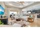 Spacious living room with hardwood floors, recessed lighting, comfortable seating, and an open layout to the kitchen at 5608 Tidewater Preserve Blvd, Bradenton, FL 34208