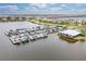 Aerial view showcasing the marina filled with boats along the waterfront, next to a charming building at 5608 Tidewater Preserve Blvd, Bradenton, FL 34208