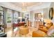 Bright home office with hardwood floors, a modern desk, and two leather armchairs at 5608 Tidewater Preserve Blvd, Bradenton, FL 34208