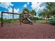 Community playground features a wooden playset with slides and swings with a soft landing on a bark ground covering at 5608 Tidewater Preserve Blvd, Bradenton, FL 34208