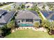 Aerial view of a private pool with screened enclosure and manicured lawn surrounded by mature palm trees at 5608 Tidewater Preserve Blvd, Bradenton, FL 34208